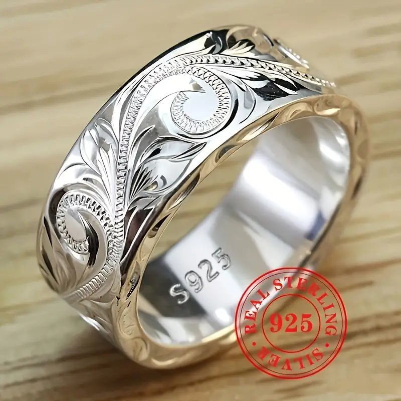 Wedding ring with engraved flower leaf motif.