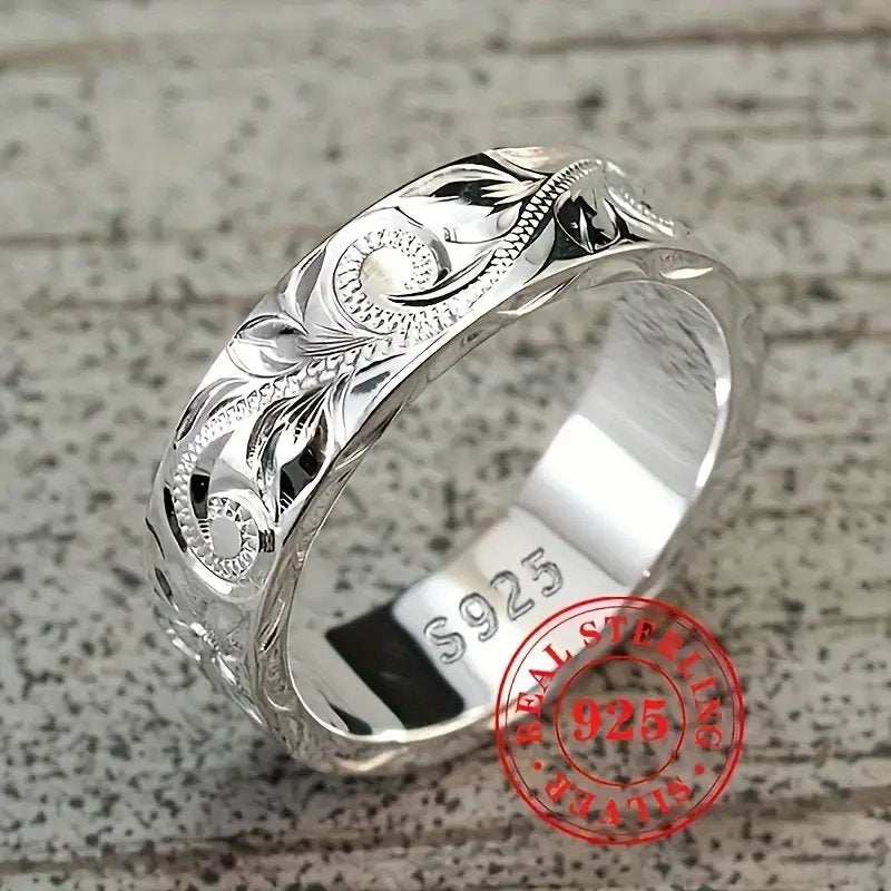 Wedding ring with engraved flower leaf motif.