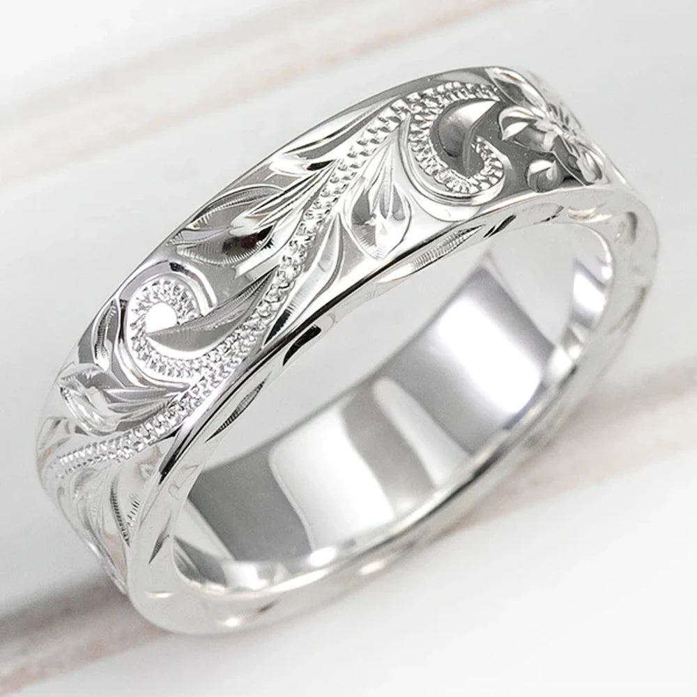 Wedding ring with engraved flower leaf motif.