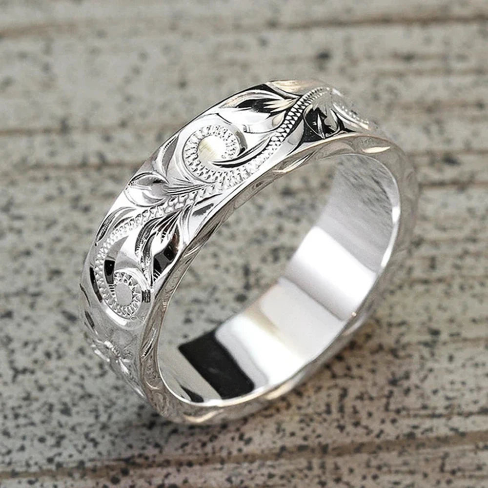 Wedding ring with engraved flower leaf motif.