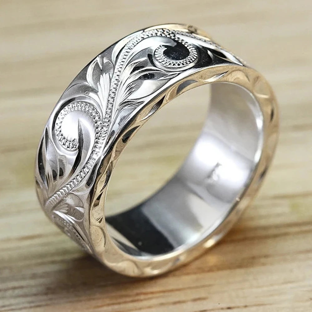 Wedding ring with engraved flower leaf motif.