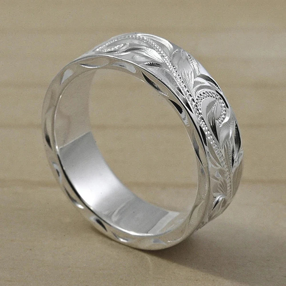 Wedding ring with engraved flower leaf motif.