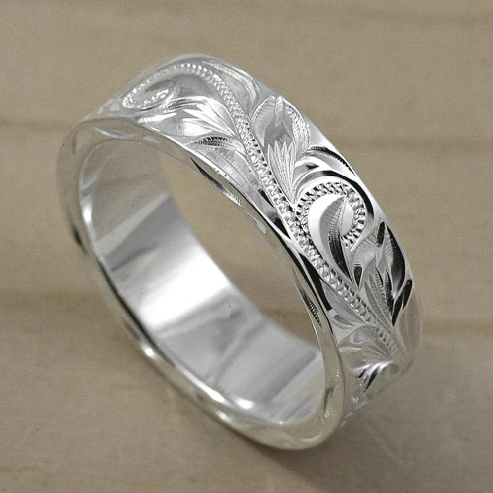 Wedding ring with engraved flower leaf motif.