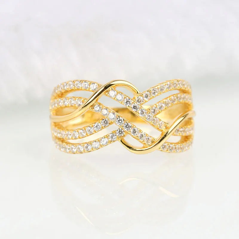 Gold colored multi-cross rings, luxury zirconia stones, elegant jewelry.