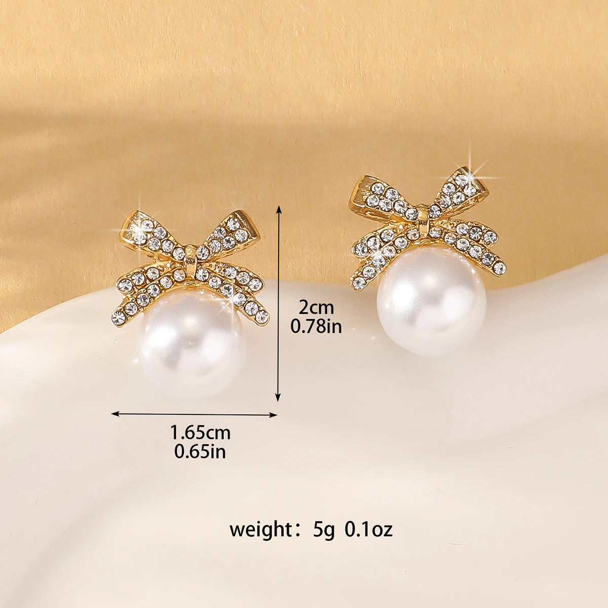 A beautiful silver bow studded with diamond pearl earrings,