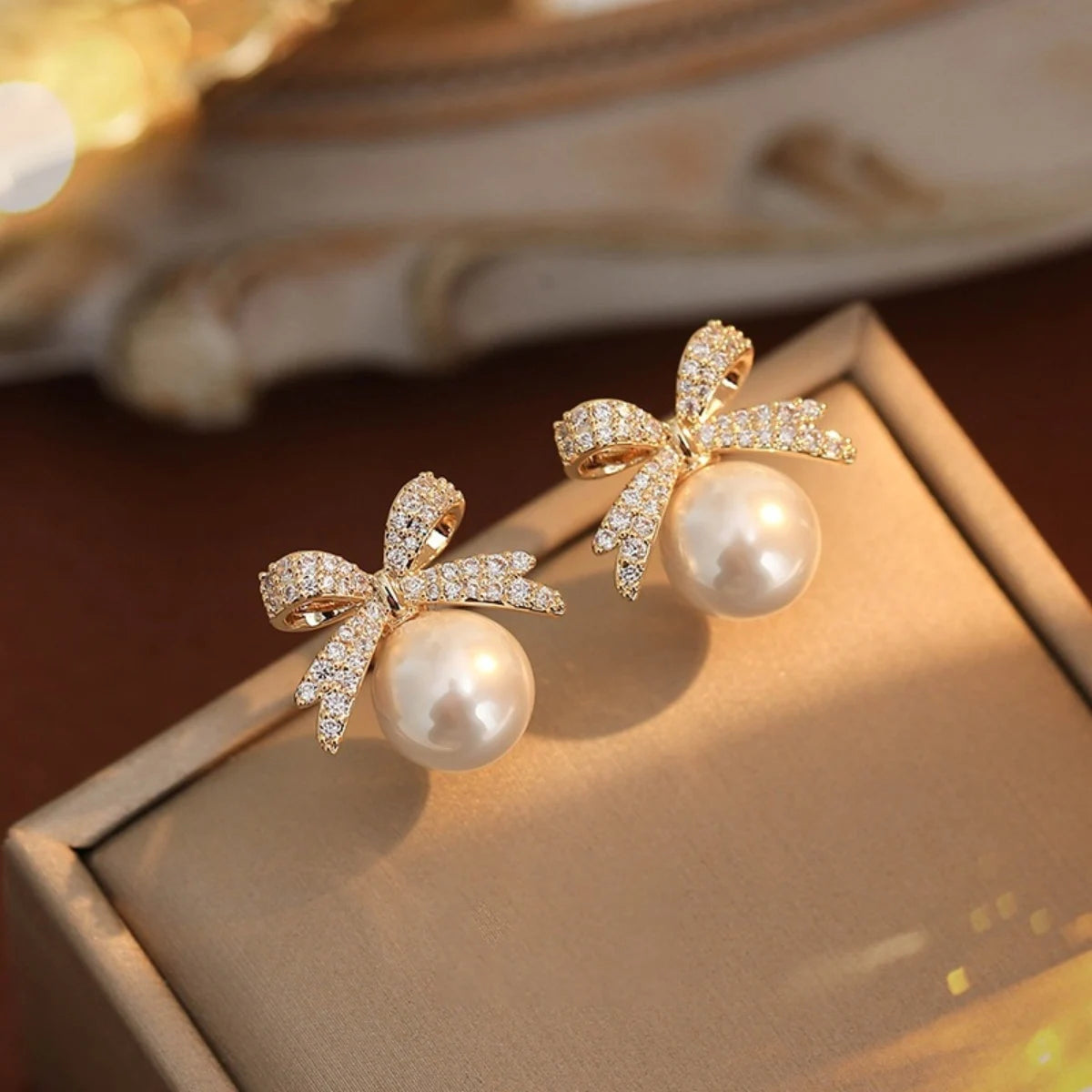 A beautiful silver bow studded with diamond pearl earrings,