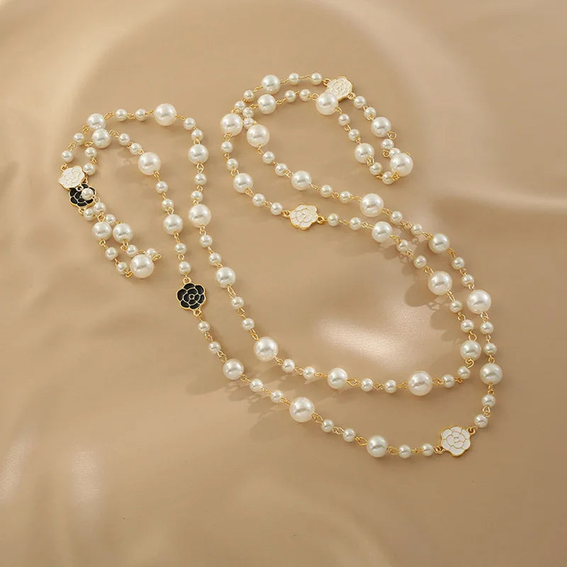 Necklace of long scented pearls.