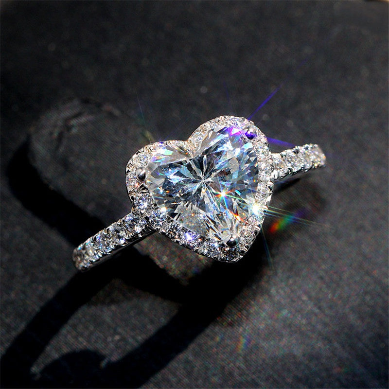 Luxury heart shaped ring, encrusted with white zircon stones.