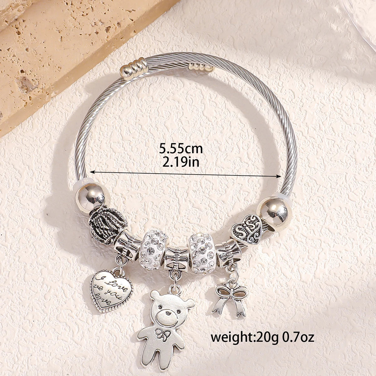 Bracelet with pearls and bear-shaped bow.