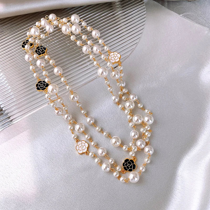 Necklace of long scented pearls.