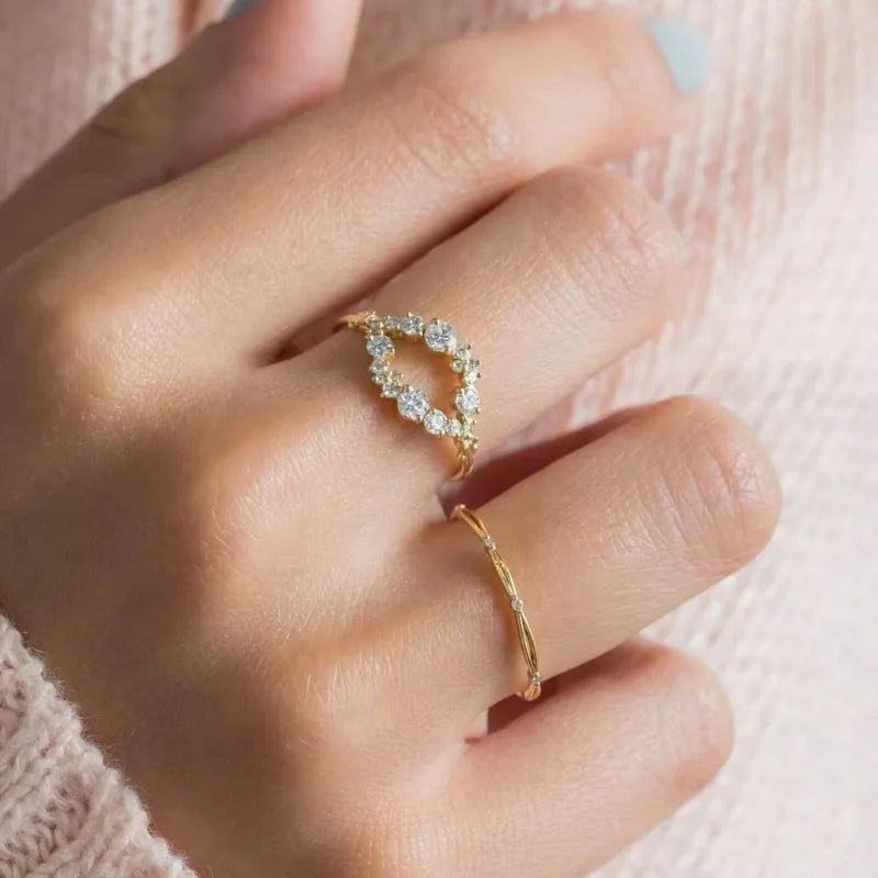 Exquisite gold colored white stone round flower ring set.