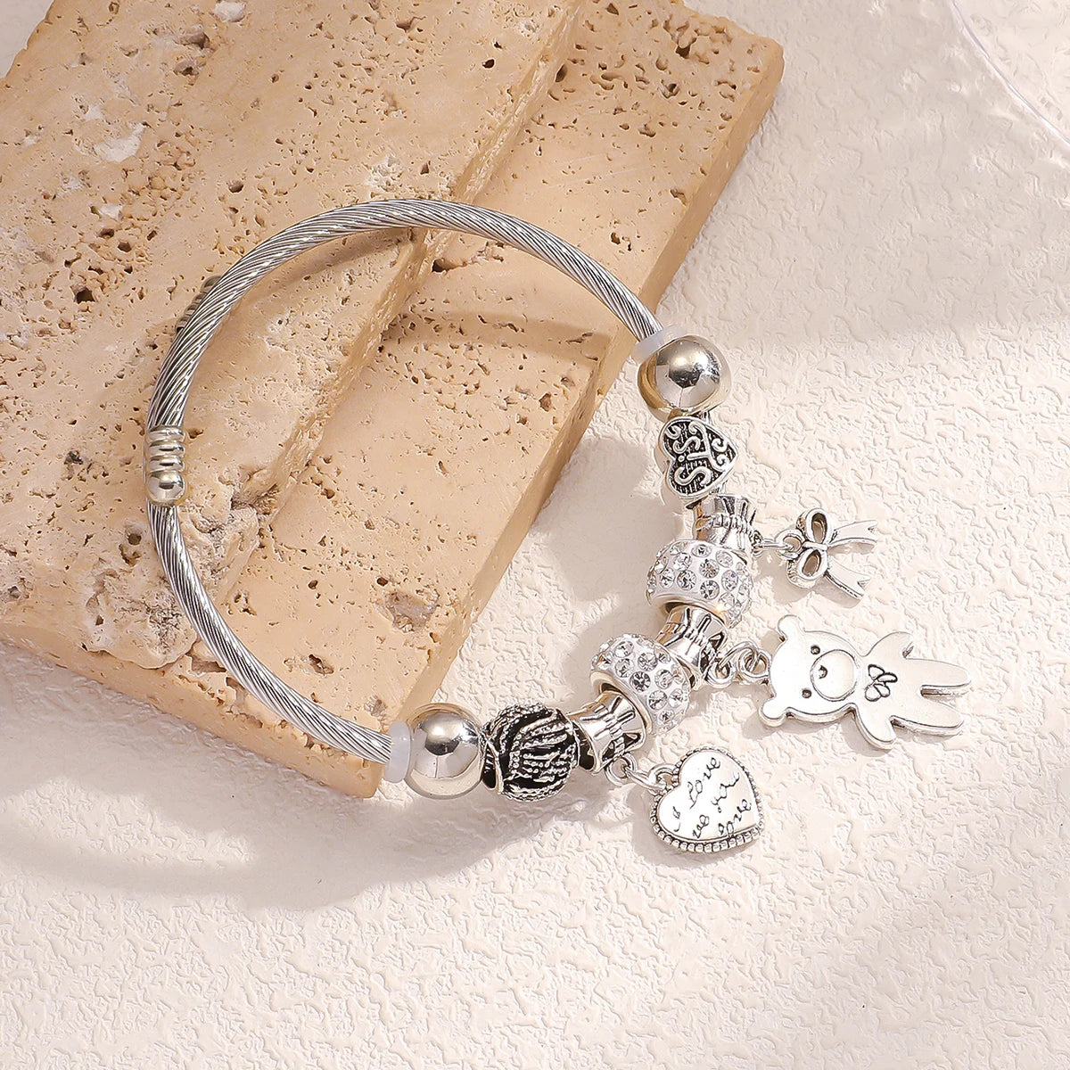 Bracelet with pearls and bear-shaped bow.